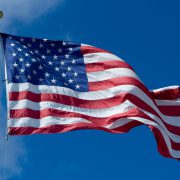 us flag waving against a blue sky