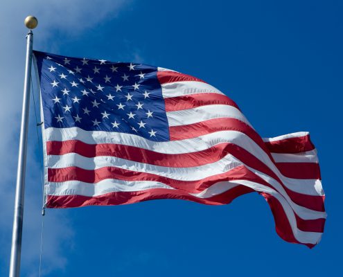 us flag waving against a blue sky