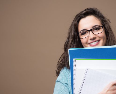 high schooler with notebooks