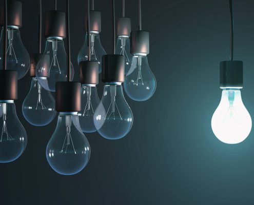 lightbulbs hanging with one lit