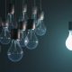 lightbulbs hanging with one lit
