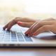 hands typing on a laptop