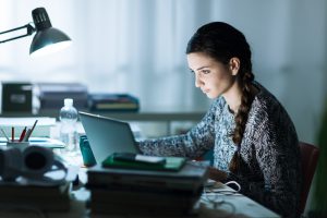 student studying digital sat at night