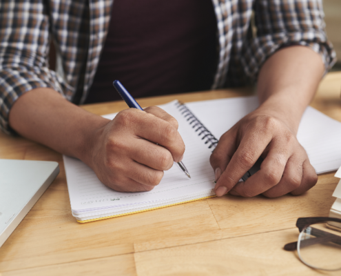 high school student working on outline for college essay